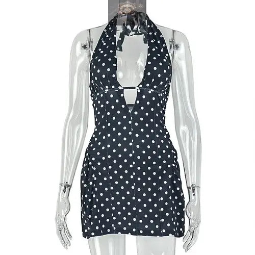 Studio shot of the black and white polka dot halter dress on a transparent mannequin - Highlighting the adjustable neck tie, deep V-cut, and slimming A-line silhouette - High-quality printed summer mini dress - ALL IN 1 WORLD