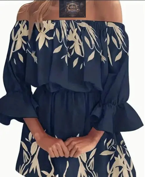 Close-up of a navy blue off-shoulder boho dress with cream leaf graphic prints - Featuring an elasticated neckline and ruffled flare sleeves - Elegant sexy backless summer style - ALL IN 1 WORLD
