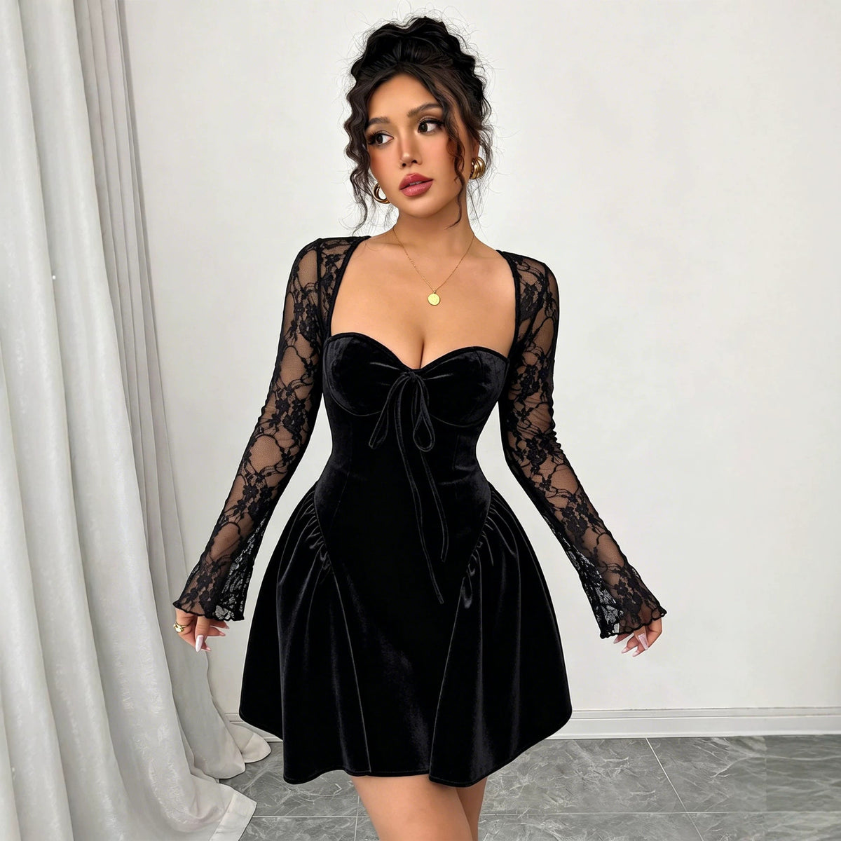 Woman wearing a black dress with long lace sleeves
