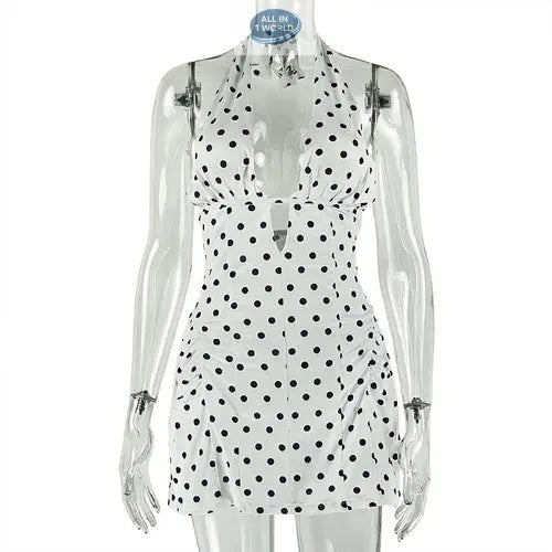 Studio product shot of the white polka dot halter mini dress on a clear mannequin - Showcasing the plunge neckline, black spot pattern, and slim A-line fit - Professional summer apparel display - ALL IN 1 WORLD