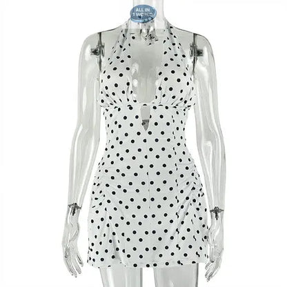 Studio product shot of the white polka dot halter mini dress on a clear mannequin - Showcasing the plunge neckline, black spot pattern, and slim A-line fit - Professional summer apparel display - ALL IN 1 WORLD