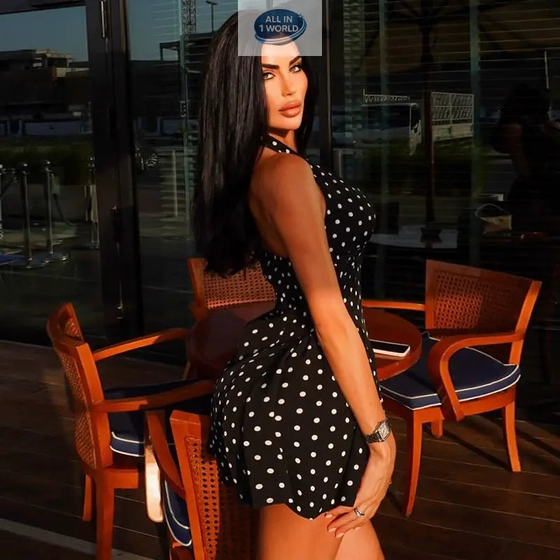 Side profile of the black polka dot slimming dress, highlighting the backless halter design and the flattering A-line fit - Elegant summer mini dress for parties - ALL IN 1 WORLD