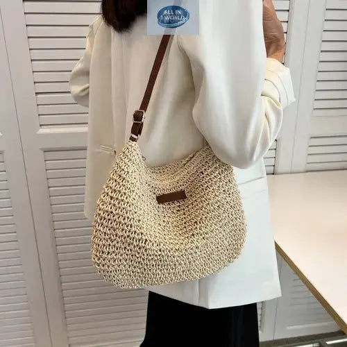 Lifestyle shot of a woman wearing the light beige summer straw shoulder bag over an elegant white blazer - Showcasing the chic bohemian-style handbag for daily urban use - ALL IN 1 WORLD