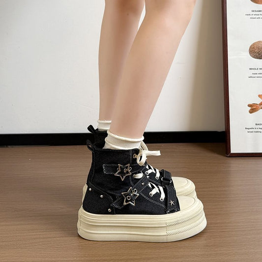 Black high-top sneakers with star-shaped decorations