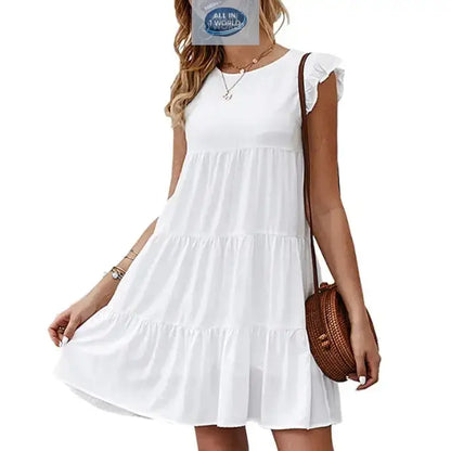 Short pure white flowy tiered dress for women with ruffled cap sleeves and round neckline - Elegant lightweight summer mini dress styled with a round brown bag - ALL IN 1 WORLD