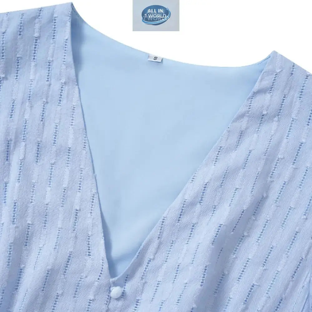 Close-up detail of a sky blue Swiss dot fabric featuring a V-neckline with a small button accent - High-quality textured summer dress material with inner lining - ALL IN 1 WORLD