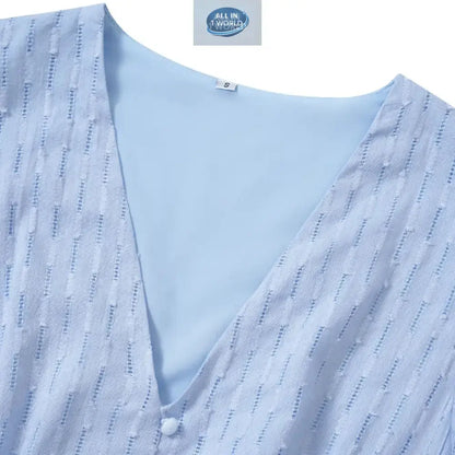 Close-up detail of a sky blue Swiss dot fabric featuring a V-neckline with a small button accent - High-quality textured summer dress material with inner lining - ALL IN 1 WORLD