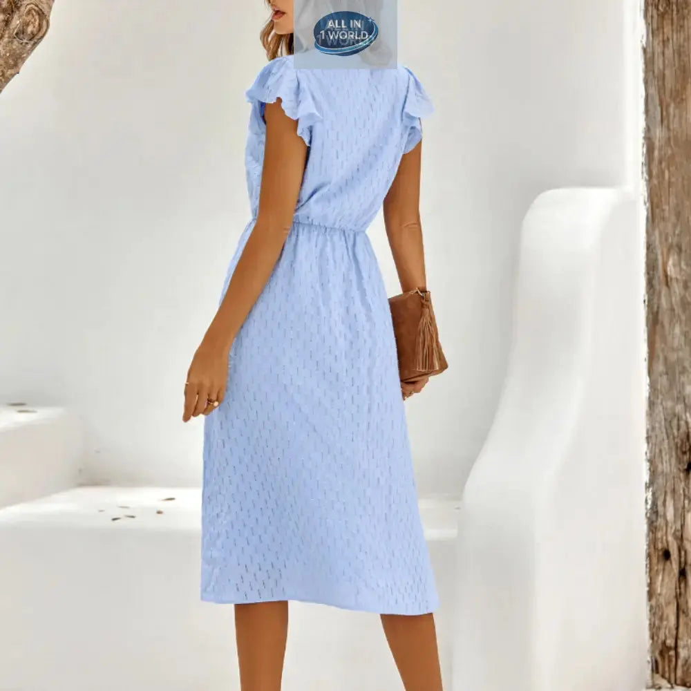 Back view of a sky blue Swiss dot midi dress showing the flowy skirt and elasticated waist - Elegant ruffled sleeves and modest summer design for women - ALL IN 1 WORLD