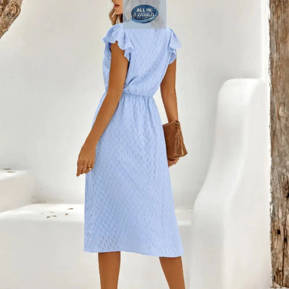 Back view of a sky blue Swiss dot midi dress showing the flowy skirt and elasticated waist - Elegant ruffled sleeves and modest summer design for women - ALL IN 1 WORLD