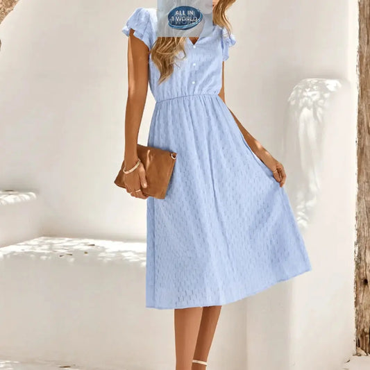 Elegant sky blue Swiss dot midi dress with a V-neckline and ruffled cap sleeves - Flowy A-line summer dress for women with an elasticated waist - Styled with a brown clutch - ALL IN 1 WORLD