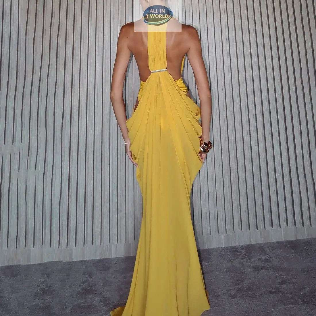 Back view of the elegant yellow spring gown, showcasing an open-back design with sophisticated draped fabric and a flowing floor-length train - High-end evening fashion - ALL IN 1 WORLD